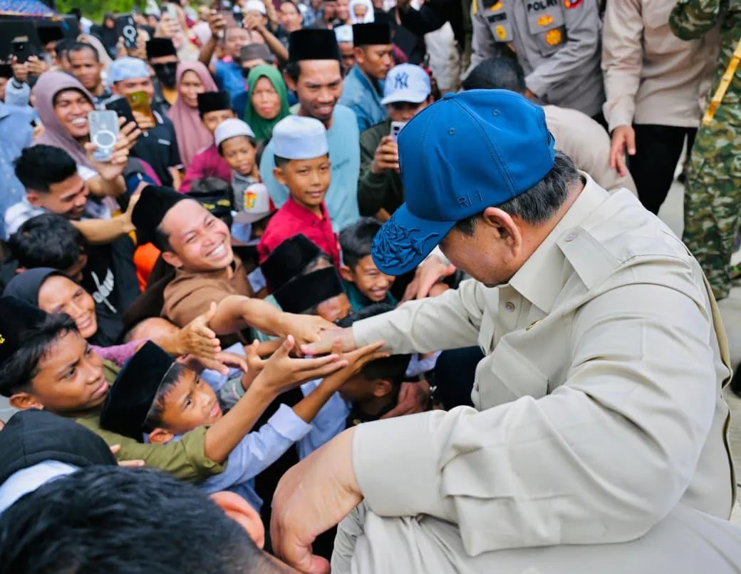 Warga dari berbagai usia tampak memadati sisi jalan untuk menyambut kedatangan Presiden Prabowo.